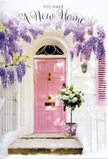 A charming Brockley entranceway is captured here at the very moment it seems ready to greet its new owners. The focal point is a pale pink front door, painted in a tender, pastel shade that radiates quiet warmth against surrounding whitewashed walls, reminiscent of the characterful homes tucked around Hilly Fields. Overhead, wisteria spills down in cascading trails of lavender and soft purple, the blossoms forming a natural canopy that arches around the doorway. Each dangling flower cluster contributes to a sense of movement and fragrance, as if the air just outside the house is laced with gentle perfume. On the doorstep, a grey metal bucket sits firmly on the stone, transformed from something simple into something special by the florist's touch. It is packed with creamy white roses, their rounded heads open and full, creating a cushion of velvety petals. Wisps of fresh green foliage weave between the blooms, softening the edges and adding an organic, garden-picked feel. A pale pink ribbon is wrapped around the bucket's base and tied into a modest bow, mirroring the door's hue and uniting all the colours into a seamless pastel story. Dappled sunlight filters across the scene, creating soft shadows on the step and door, and giving the impression of a still, hopeful afternoon somewhere off Brockley Road. The whole composition feels like a floral blessing placed right at the threshold-ideal as a housewarming arrangement delivered locally, capturing the mix of nerves, excitement, and optimism that come with starting a new life in a Brockley home.