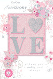 This anniversary card captures the gentle romance of a long, shared journey, its soft pastel pinks and silvery greys echoing the subtle tones of a quiet evening walk through Brockley's tree-lined streets. At the very centre, the word LOVE is picked out in soft, raised glitter, the texture inviting the fingertips to explore. The letter O is replaced by a shimmering silver heart, textured and luminous, becoming the emotional anchor of the design, like a single statement bloom in a carefully crafted arrangement. Around this heart-centred word, delicate blossoms in blush, mauve, and hints of ivory drift outward with a watercolour softness. Their fine, flowing outlines and lightly shaded petals evoke the precise touch of an experienced florist arranging gentle anniversary flowers for delivery around Brockley and the nearby conservation areas. Tiny flourishes dance between the blooms-curved tendrils, scattered petals, and small, almost elusive butterflies that add a sense of movement and playful grace. The background is a calm, pale pink wash, providing a serene stage for the floral artwork and allowing each silver detail to catch the light. The inscriptions On Our Anniversary and I love you today and always appear in an elegant, understated script that feels personal rather than formal, as if handwritten in a cherished card. Overall, the composition suggests a quiet but deeply felt celebration: a keepsake that, like a beloved bouquet on the kitchen table, marks an anniversary not only as a date on the calendar, but as a tender, ongoing story shared at home in Brockley.